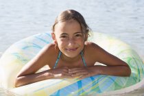 Portrait of girl in inflatable ring in Lake Seeoner See, Bavaria, Germany — Stock Photo