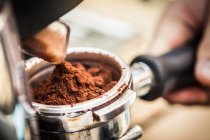 Close up of espresso grounds in machine — Stock Photo