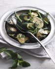 Bowl roasted courgettes with green beans and spoon on table — Stock Photo