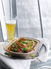 Stewed meat with glass of beer — Stock Photo