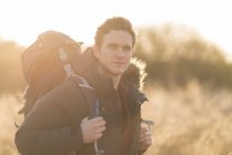 Portrait of young man hiking in rural setting — Stock Photo