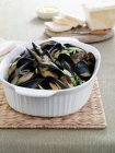 Close-up view of dish of mussels and herbs — Stock Photo