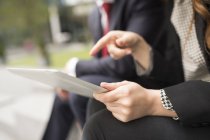 Cropped view of businesspeople using digital tablet — Stock Photo