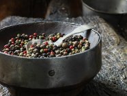 Close up of spice in vintage bowl, rustic wooden chopping board — Stock Photo
