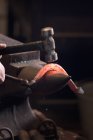 Farrier forging horseshoe on anvil, cropped image — Stock Photo