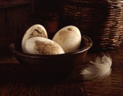 Organic goose eggs in vintage wooden bowl — Stock Photo