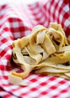 Fresh pasta in cloth — Stock Photo