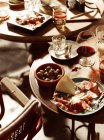 Antipasto starters with beer and wine on tables — Stock Photo