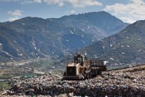 Machinery working on waste in landfill — Stock Photo