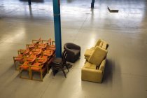 Chairs in empty warehouse — Stock Photo