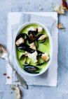 Bowl of pea and mussels soup — Stock Photo