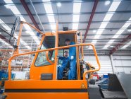 Engineers in cab of tow truck in truck repair factory — Stock Photo