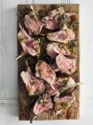 Top view of roasted lamb cutlets on cutting board with  rosemary — Stock Photo