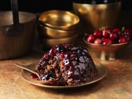 Eaten black forest christmas pudding with spoon on plate — Stock Photo