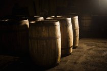 Wooden whisky casks in brewery — Stock Photo