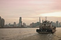 Stadtsilhouette und Boot im urbanen Fluss — Stockfoto