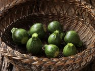 Fresh organic vegetables, baby round courgettes in basket — Stock Photo