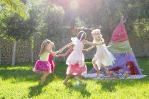 Five girls in fairy costumes playing in garden — Stock Photo