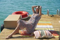 Woman sunbathing on houseboat sun deck, Kraalbaai, South Africa — Stock Photo