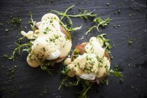 Top view of hollandaise sauce with eggs benedict — Stock Photo