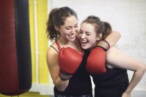 Two female boxing friends pretending to punch in gym — Stock Photo