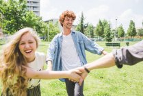 Friends circle dancing in park together — Stock Photo