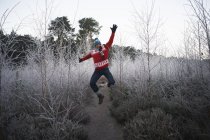 Man jumping in rural winter scene — Stock Photo