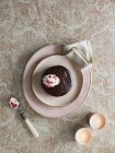 Chocolate cake with dollop of cream, top view — Stock Photo