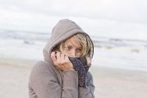Mujer con bufanda en la playa - foto de stock