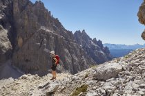 Female hiker looking out at Dolomites, Sexten, South Tyrol, Italy — Stock Photo