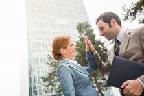 Business people high fiving outdoors — Stock Photo