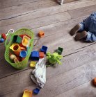 Babys toys on wooden floor, overhead view — Stock Photo