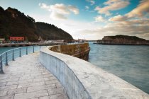 Ornate stone walkway at harbor under cloudy sky — Stock Photo