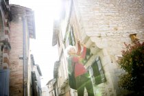 Woman taking photograph in street, Bruniquel, France — Stock Photo