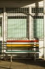 Bench outside building in bright sunlight — Stock Photo