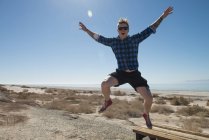 Man jumping mid air, Salton Sea, California , USA — Stock Photo