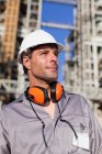 Worker standing at oil refinery — Stock Photo