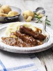 Portion of vegetarian sausages and mashed potatoes with fork — Stock Photo