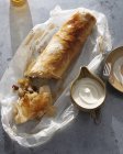 Overhead view of apple strudel and cream on table — Stock Photo
