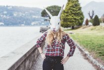 Ritratto di donna mascherata da coniglio con le mani sui fianchi, Lago di Como, Italia — Foto stock