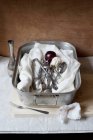Cheesecloth with utensil and ripe plum in tray — Stock Photo