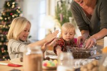 Mother and daughters baking for Christmas dinner — Stock Photo
