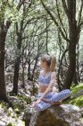 Woman practising yoga in forest — Stock Photo