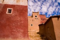 Colorful ancient buildings and blue cloudy sky — Stock Photo