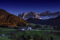 Distant view of small town at nighttime, Dolomites, Italy — Stock Photo