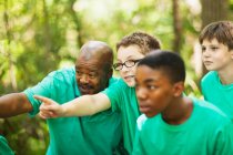 Students exploring forest with teacher — Stock Photo