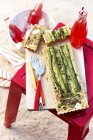 Top view of asparagus and goats cheese tart on table on sand — Stock Photo