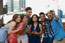 Friends taking selfie at early evening party — Stock Photo