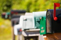 Mailboxes standing in row, differential focus — Stock Photo