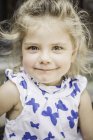Close up portrait of female toddler in butterfly dress — Stock Photo